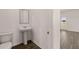 Powder room with a pedestal sink, tile flooring, and a door leading to the outside at 301 Sandy Oak Dr, Loganville, GA 30052