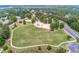 Aerial view of neighborhood playground with green space, trees and parking, inviting outdoor fun at 424 Lake Point Trce, Canton, GA 30114