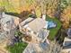 Aerial view of a brick home with a pool, a large yard, and mature trees at 424 Lake Point Trce, Canton, GA 30114