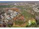 Stunning aerial view of a neighborhood in fall, with a golf course visible in the foreground and mature trees at 424 Lake Point Trce, Canton, GA 30114