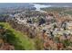 Picturesque aerial view of a neighborhood in fall, showcasing waterfront properties and scenic surroundings, with a golf course at 424 Lake Point Trce, Canton, GA 30114