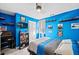 Bright blue bedroom featuring train decor, a ceiling fan, and a television at 424 Lake Point Trce, Canton, GA 30114