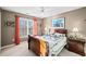 Cozy bedroom with natural light, ceiling fan, and carpet floors at 424 Lake Point Trce, Canton, GA 30114