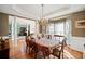 Elegant dining room featuring hardwood floors, a large table, and natural light streaming through the bay window at 424 Lake Point Trce, Canton, GA 30114