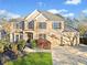 Charming two-story brick home featuring well-manicured landscaping, a two-car garage, and traditional wooden shutters at 424 Lake Point Trce, Canton, GA 30114