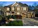 Beautiful brick home featuring a manicured lawn, lush landscaping, and a two-car garage at 424 Lake Point Trce, Canton, GA 30114