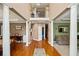 A spacious hallway features hardwood floors and elegant columns, connecting various rooms in the home at 424 Lake Point Trce, Canton, GA 30114