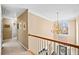 Hallway with chandelier, railing, neutral paint, and an outside view at 424 Lake Point Trce, Canton, GA 30114