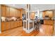 Modern kitchen with wooden cabinets, granite countertops, and a convenient island with bar stools at 424 Lake Point Trce, Canton, GA 30114