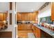 Well-lit kitchen featuring granite countertops, wooden cabinets, and a modern sink at 424 Lake Point Trce, Canton, GA 30114