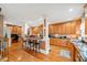 Spacious open kitchen with hardwood flooring, granite counters, breakfast bar, and custom cabinetry at 424 Lake Point Trce, Canton, GA 30114