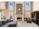 Bright living room with a fireplace, large windows, and cozy seating at 424 Lake Point Trce, Canton, GA 30114
