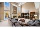 Bright living room features soaring ceilings, multiple windows, a fireplace, and comfortable seating at 424 Lake Point Trce, Canton, GA 30114