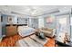 Serene main bedroom featuring a bed, sofa, wooden dresser, and light blue walls at 424 Lake Point Trce, Canton, GA 30114