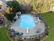 Aerial view of a backyard pool with a diving board, slide, and surrounding lounge area at 424 Lake Point Trce, Canton, GA 30114