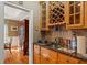 Well-appointed wet bar features granite counters, wine rack, storage, and close proximity to the dining room at 424 Lake Point Trce, Canton, GA 30114