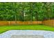Spacious backyard with lush lawn, privacy fence, and decorative rock border at 7006 Mahonia Place, Stonecrest, GA 30038
