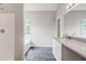 Bright bathroom with a modern vanity, mirror, and gray hardwood floors at 7006 Mahonia Place, Stonecrest, GA 30038