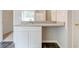 A bright bathroom features a modern vanity and gray hardwood floors at 7006 Mahonia Place, Stonecrest, GA 30038