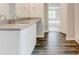 Modern bathroom with double sink vanity, granite countertops, and wood-look tile flooring at 7006 Mahonia Place, Stonecrest, GA 30038