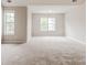 This bedroom features bright light, plush carpeting, and neutral walls at 7006 Mahonia Place, Stonecrest, GA 30038