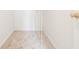 Walk-in closet featuring neutral carpeting, white walls, and a brass doorknob at 7006 Mahonia Place, Stonecrest, GA 30038