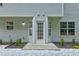 Rear exterior featuring French doors, a patio, and manicured landscaping at 7006 Mahonia Place, Stonecrest, GA 30038