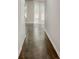 Hallway with wood floors that leads to a bright room with windows and doors at 7006 Mahonia Place, Stonecrest, GA 30038