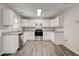 Bright kitchen featuring white cabinets, gray counters, and stainless steel appliances at 7006 Mahonia Place, Stonecrest, GA 30038