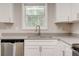Bright kitchen with stainless steel appliances, white cabinets, and gray countertop at 7006 Mahonia Place, Stonecrest, GA 30038