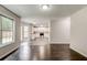 View of living room flows to bright kitchen with white cabinets and stainless steel appliances at 7006 Mahonia Place, Stonecrest, GA 30038