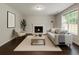 Bright living room with fireplace, hardwood floors, and natural light at 7006 Mahonia Place, Stonecrest, GA 30038