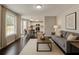 Open concept living space with hardwood floors, white trim, and view of kitchen at 7006 Mahonia Place, Stonecrest, GA 30038