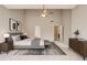 Spacious main bedroom featuring high ceilings, modern decor, ceiling fan, and neutral walls and carpet at 7006 Mahonia Place, Stonecrest, GA 30038
