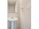 Pedestal sink and mirror in the half bathroom at 7006 Mahonia Place, Stonecrest, GA 30038