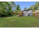 A well-maintained backyard with a wooden deck, green grass, and a fence, offering a private outdoor space at 845 Oak Nw St, Atlanta, GA 30318