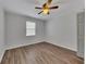 This bedroom has a neutral color palette and attractive wood laminate flooring at 845 Oak Nw St, Atlanta, GA 30318