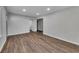 Spacious living room featuring vinyl flooring, recessed lighting, and neutral colors at 845 Oak Nw St, Atlanta, GA 30318