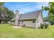 Lush backyard with green grass and a back exterior of a house with a chimney at 169 Winding Valley Dr, Rockmart, GA 30153