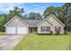 Charming single-story home with a two-car garage, well-maintained lawn, and lovely landscaping at 169 Winding Valley Dr, Rockmart, GA 30153