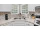 Bright kitchen with stainless appliances, white cabinetry, backsplash and hardwood flooring at 169 Winding Valley Dr, Rockmart, GA 30153