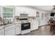 Bright kitchen with stainless appliances, white cabinetry, modern hardware and hardwood flooring at 169 Winding Valley Dr, Rockmart, GA 30153