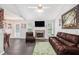 Open-concept living area with a fireplace, TV, and seamless flow to the dining and kitchen areas at 169 Winding Valley Dr, Rockmart, GA 30153