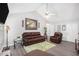 Bright living room with vaulted ceiling, neutral walls, and cozy brown leather furniture at 169 Winding Valley Dr, Rockmart, GA 30153