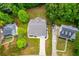 Aerial shot of the home highlighting its roof, landscaping, and surrounding neighborhood at 9691 Squirrel Wood Run, Douglasville, GA 30135