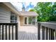 A wooden back deck offers outdoor living space with access to a screened-in porch at 9691 Squirrel Wood Run, Douglasville, GA 30135