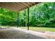 Covered patio with view of a spacious, green backyard with mature trees and landscaping at 9691 Squirrel Wood Run, Douglasville, GA 30135