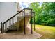Backyard view with a wooden deck, stairs, and patio area for outdoor living at 9691 Squirrel Wood Run, Douglasville, GA 30135