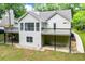 A home with a deck and covered patio, offering a serene backyard retreat at 9691 Squirrel Wood Run, Douglasville, GA 30135