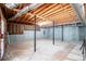 Unfinished basement ready for customization, featuring exposed wood beams, concrete flooring, and support columns at 9691 Squirrel Wood Run, Douglasville, GA 30135